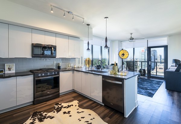 Modern kitchen with sleek appliances and granite countertops at Ascent Midtown Apartments