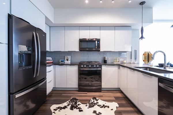 Modern kitchen with stainless steel appliances at Ascent Midtown Apartments