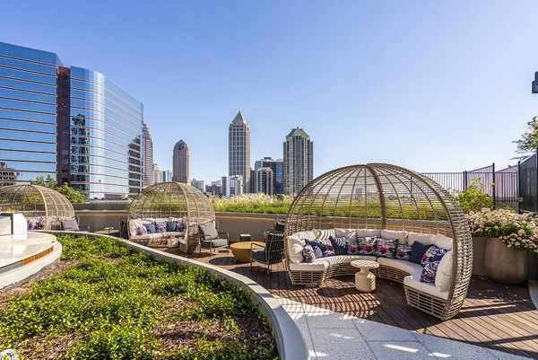 Modern outdoor patio with seating and city views at Ascent Midtown Apartments