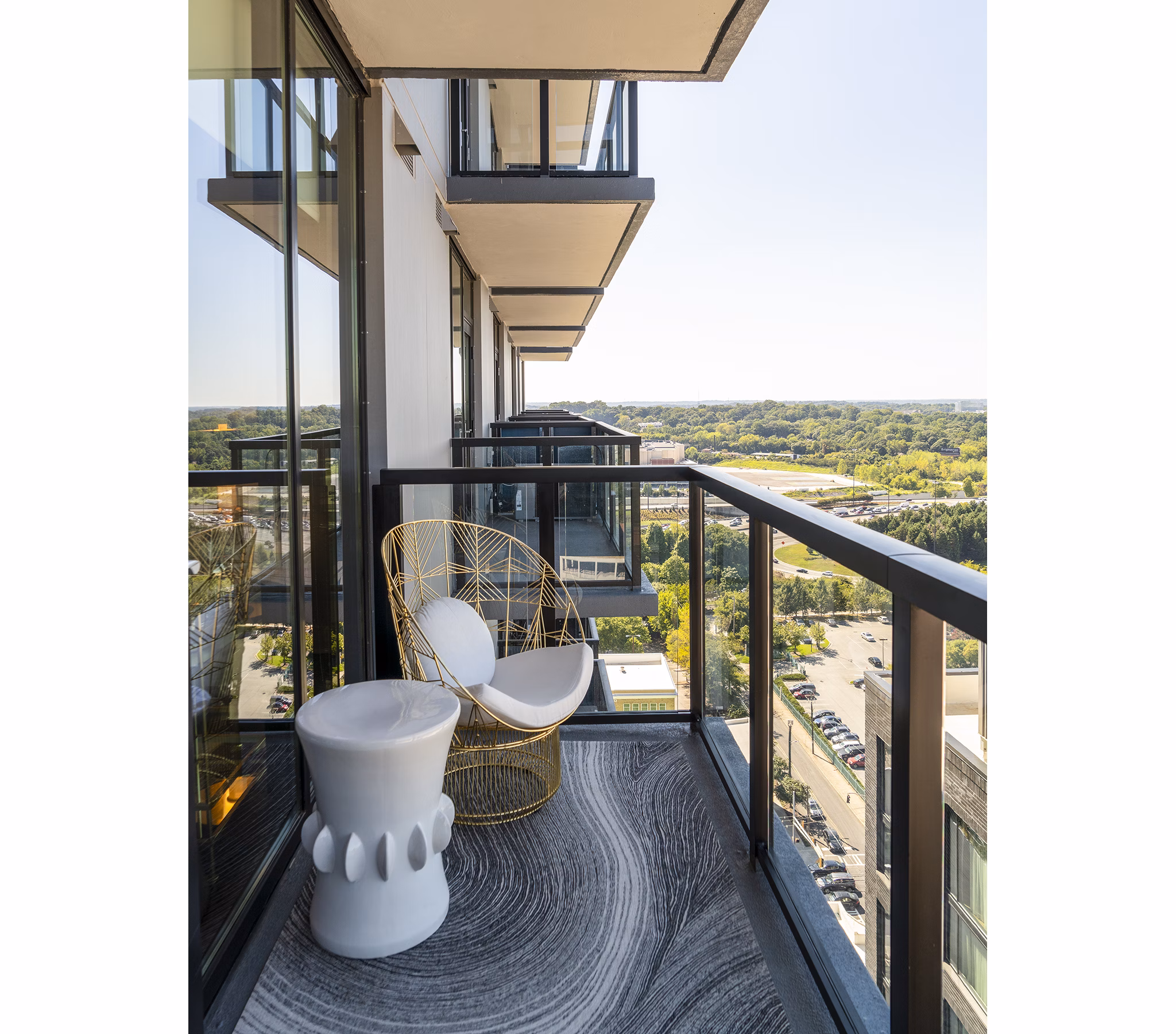 Ascent Midtown Apartments: Cozy patio balcony with modern seating for relaxing in the heart of the city