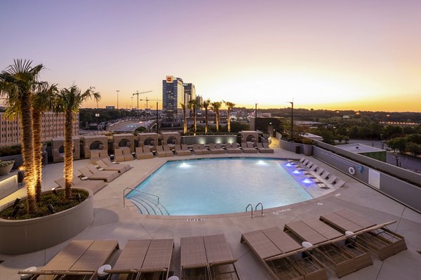 Outdoor swimming pool with lounge chairs at Ascent Midtown Apartments, a luxury property located in the heart of Atlanta