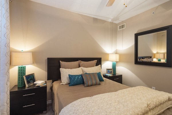 Bedroom featuring elegant decor and large windows at Mandalay at Shadow Lake Apartments