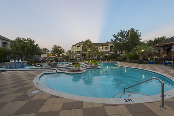 ***Spacious outdoor pool area with lounging chairs at Mandalay at Shadow Lake Apartments, offering luxury living experience***