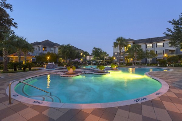 Resort-style pool with vibrant landscaping at Mandalay at Shadow Lake Apartments