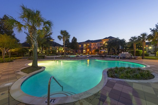 Resort-style pool with sun loungers at Mandalay at Shadow Lake Apartments