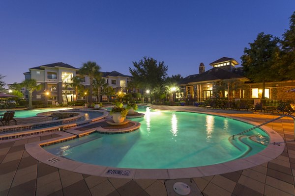 Resort-style pool with lush landscaping at Mandalay at Shadow Lake Apartments