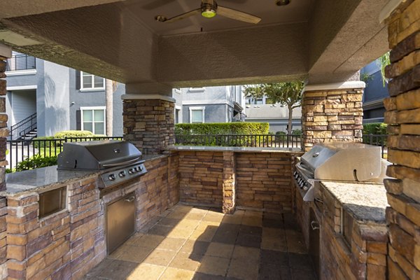 Grill area with shaded seating at Mandalay at Shadow Lake Apartments, a Greystar luxury community in convenient location