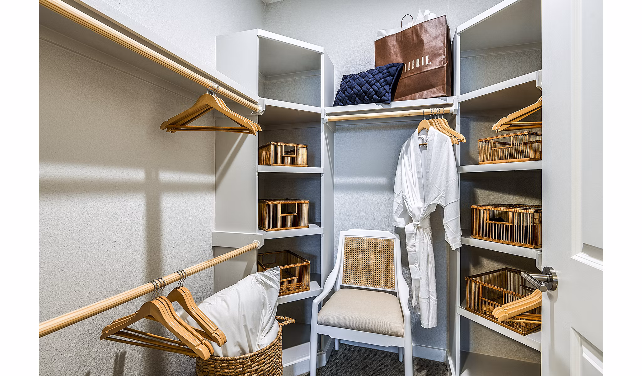 Walk-in closet with ample shelving in bedroom at Overture Dr Phillips Apartments