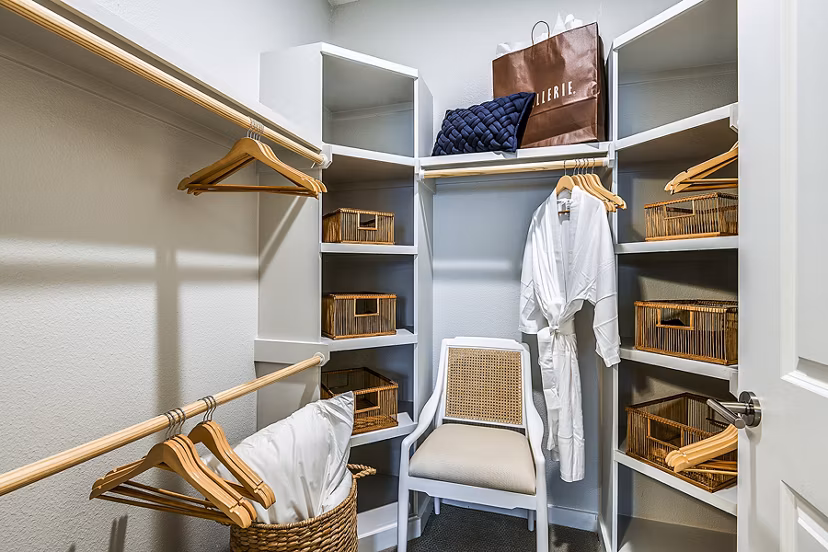 Walk-in closet with ample shelving in bedroom at Overture Dr Phillips Apartments