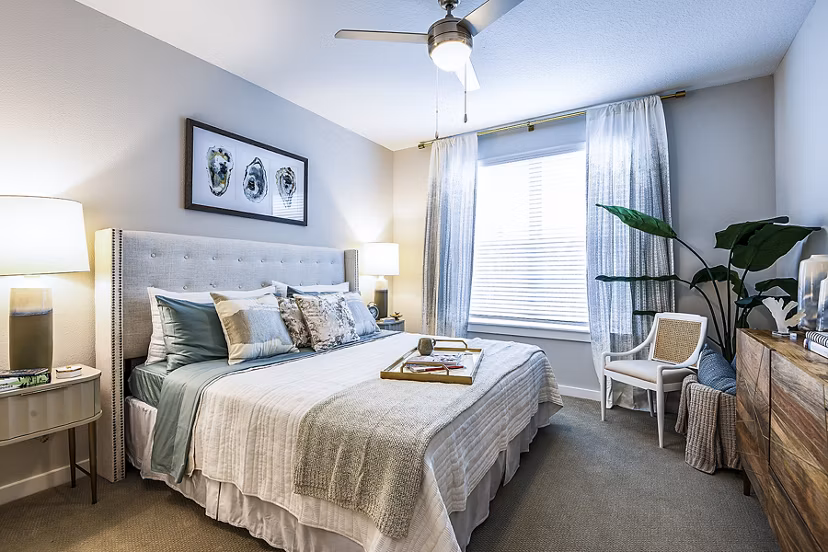 Elegant bedroom with plush bedding at Overture Dr Phillips Apartments