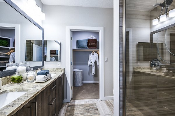 Bathroom featuring elegant marble countertops and modern fixtures at Overture Dr Phillips Apartments - luxury living by Greystar