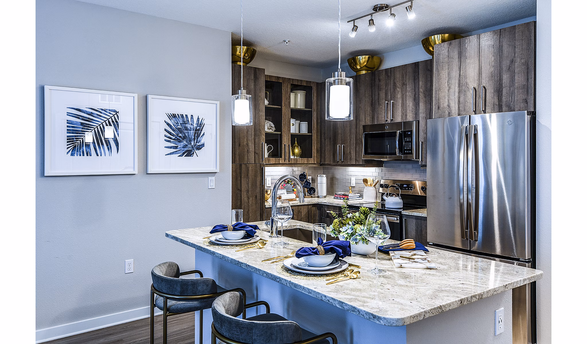 Modern kitchen with sleek cabinetry and stainless steel appliances at Overture Dr Phillips Apartments