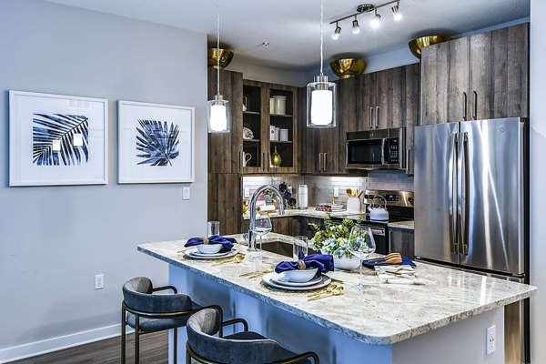 Modern kitchen with sleek cabinetry and stainless steel appliances at Overture Dr Phillips Apartments