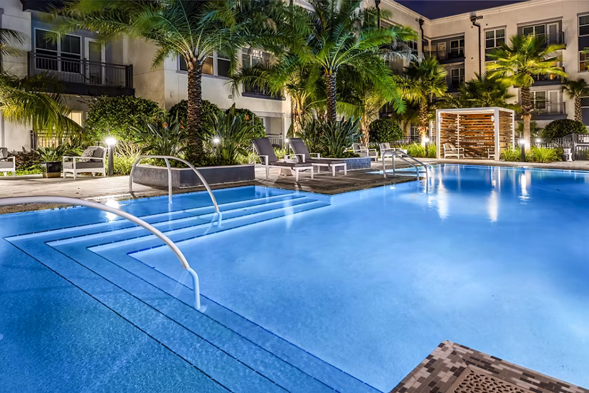 Refreshing outdoor pool at Overture Dr Phillips Apartments with modern lounge area