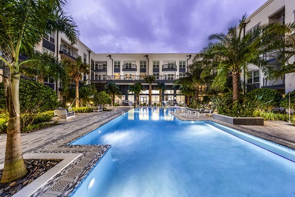 Resort-style pool with sun loungers at Overture Dr Phillips Apartments