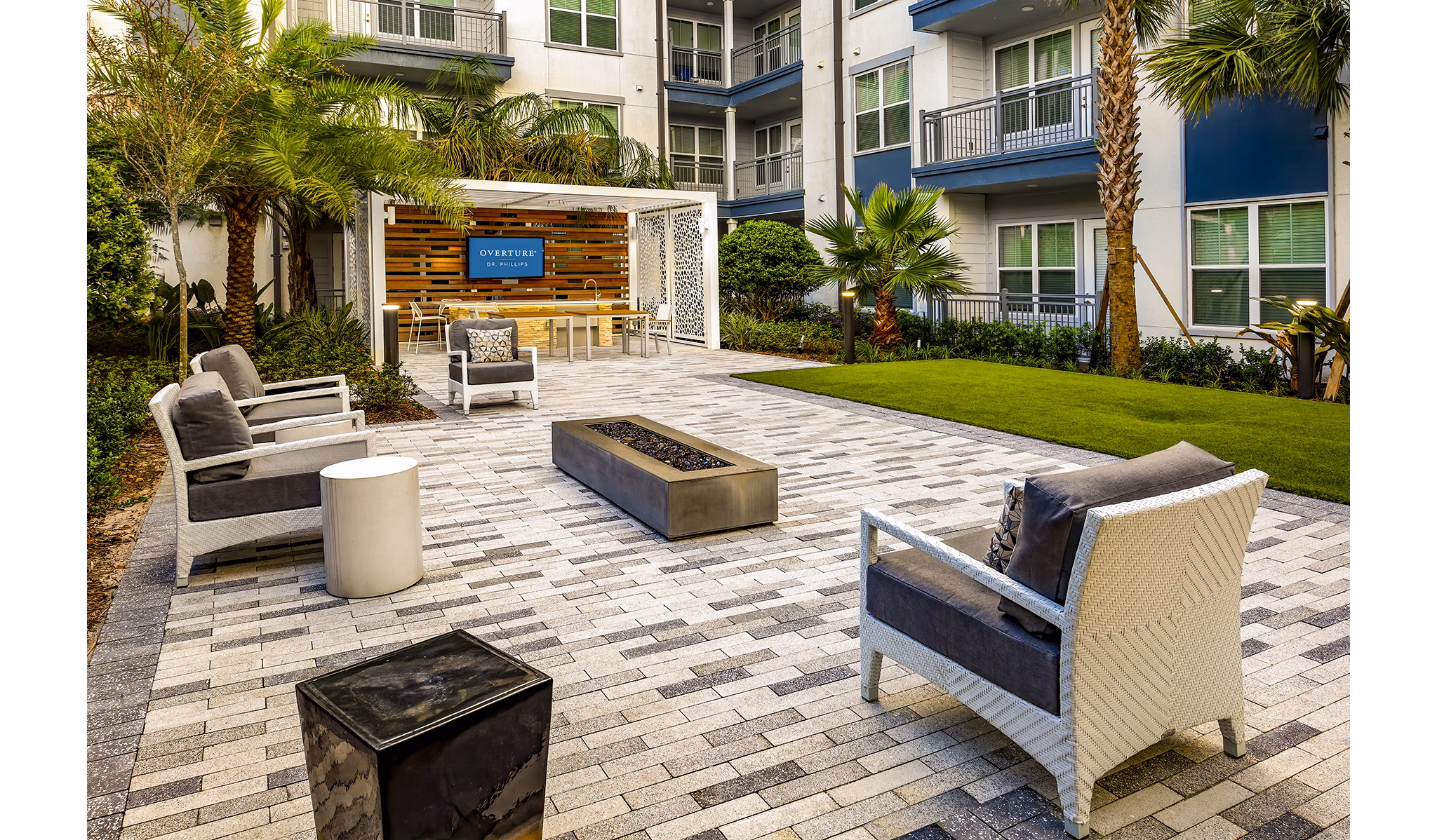 Cozy fire pit area at Overture Dr Phillips Apartments offering a warm, inviting outdoor space for relaxation and socializing