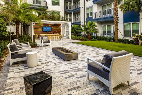 Cozy fire pit area at Overture Dr Phillips Apartments offering a warm, inviting outdoor space for relaxation and socializing
