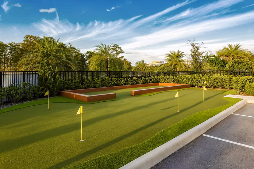 Charming putting green at Overture Dr Phillips Apartments, Orlando, ideal for resident golf enthusiasts seeking leisure and relaxation