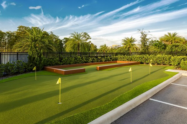 Charming putting green at Overture Dr Phillips Apartments, Orlando, ideal for resident golf enthusiasts seeking leisure and relaxation