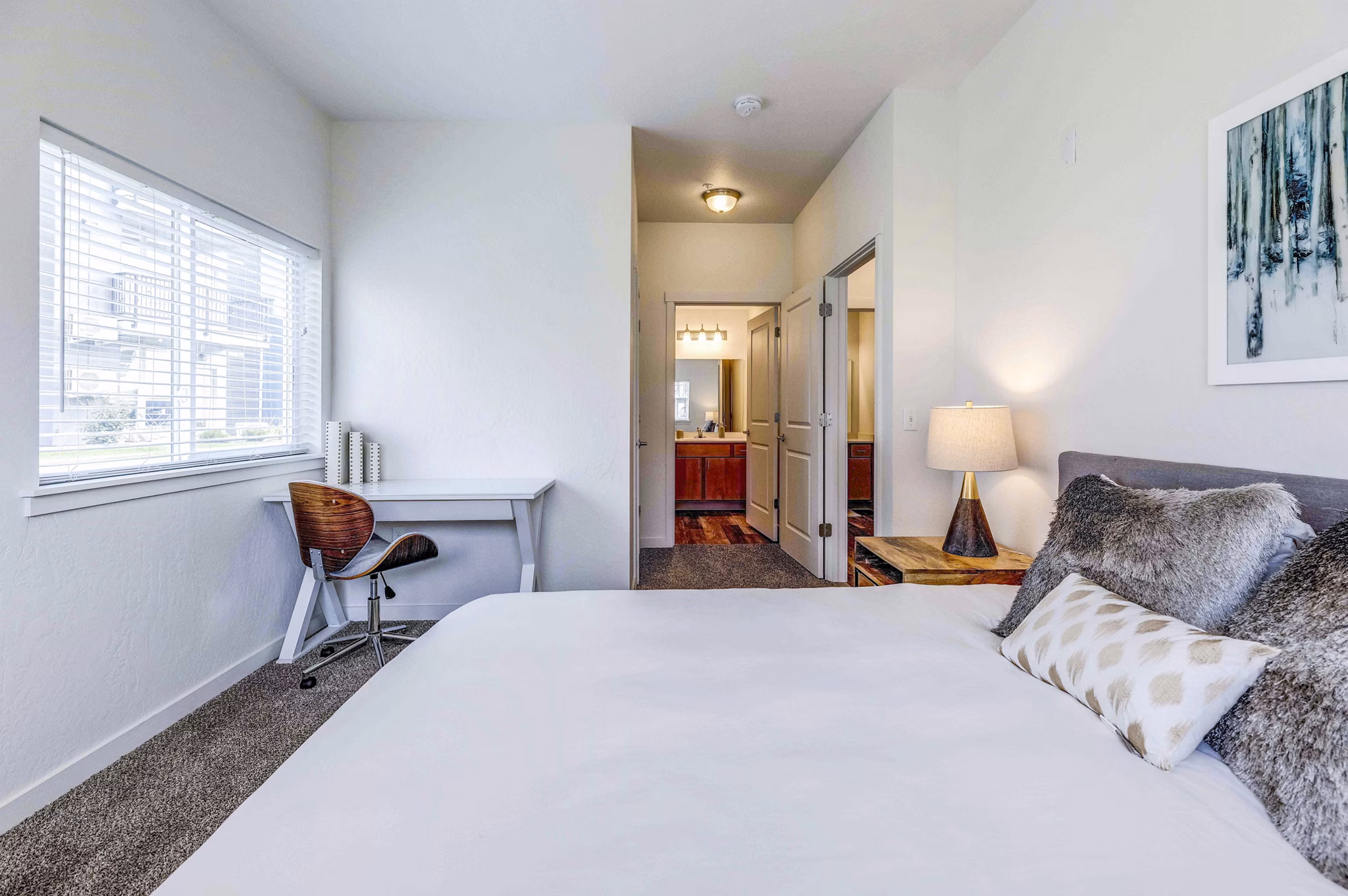 Cozy bedroom featuring elegant decor and spacious layout at The Northern at Coeur d'Alene Place Apartments