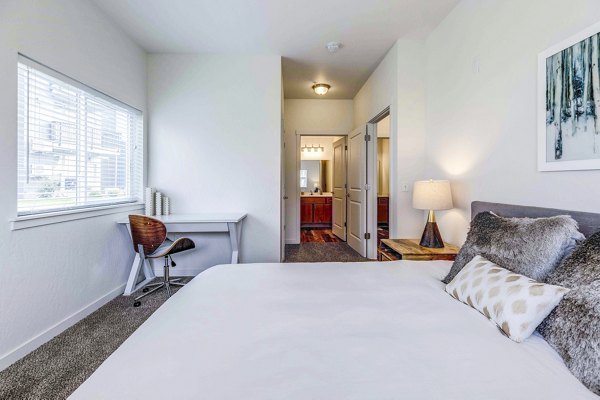 Cozy bedroom featuring elegant decor and spacious layout at The Northern at Coeur d'Alene Place Apartments