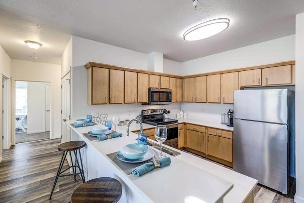Modern kitchen with stainless steel appliances at The Northern at Coeur d'Alene Place Apartments