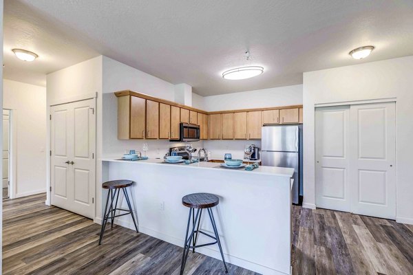 Modern kitchen with stainless steel appliances at The Northern at Coeur d'Alene Place Apartments