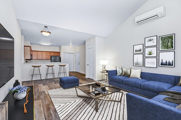 Spacious living room with modern decor at The Northern at Coeur d'Alene Place Apartments