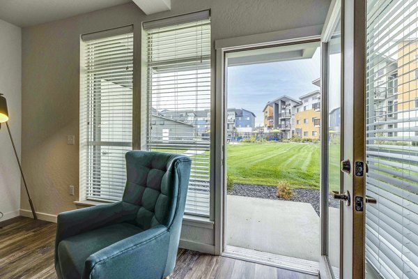 Spacious living room with modern decor in The Northern at Coeur d'Alene Place Apartments