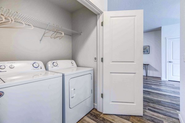 Laundry room with modern appliances at The Northern at Coeur d'Alene Place Apartments