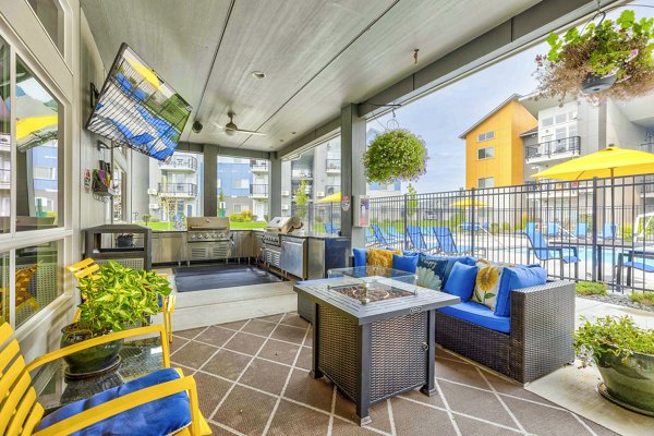 Grill area on the patio featuring outdoor seating at The Northern at Coeur d'Alene Place Apartments