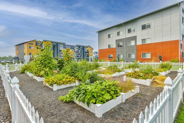 Community garden with vibrant plants at The Northern at Coeur d'Alene Place Apartments