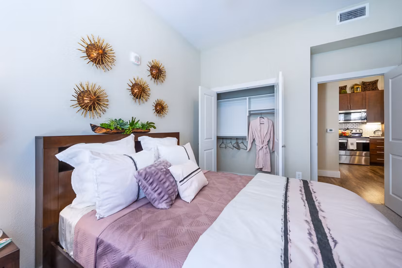 Cozy bedroom with modern furnishings at Hardy Yards Apartment Homes