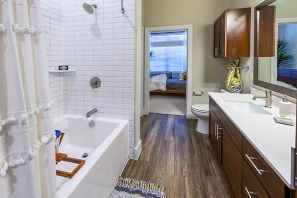 Modern bathroom with sleek fixtures at Hardy Yards Apartment Homes, featuring luxury Greystar design in Houston