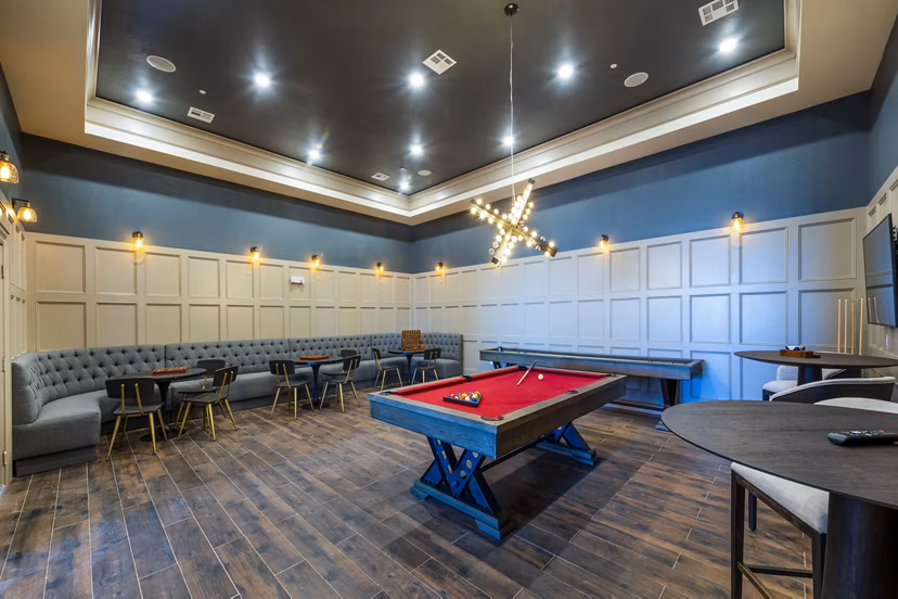 Clubhouse game room with pool table and seating at Hardy Yards Apartment Homes, luxury apartments offering recreational amenities