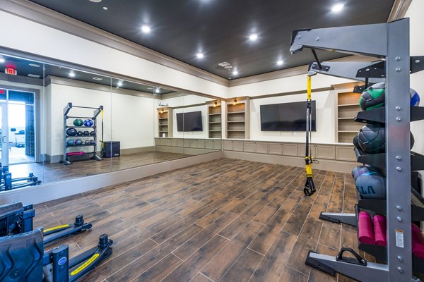 Modern fitness center with state-of-the-art equipment at Hardy Yards Apartment Homes, offering residents a premier workout experience