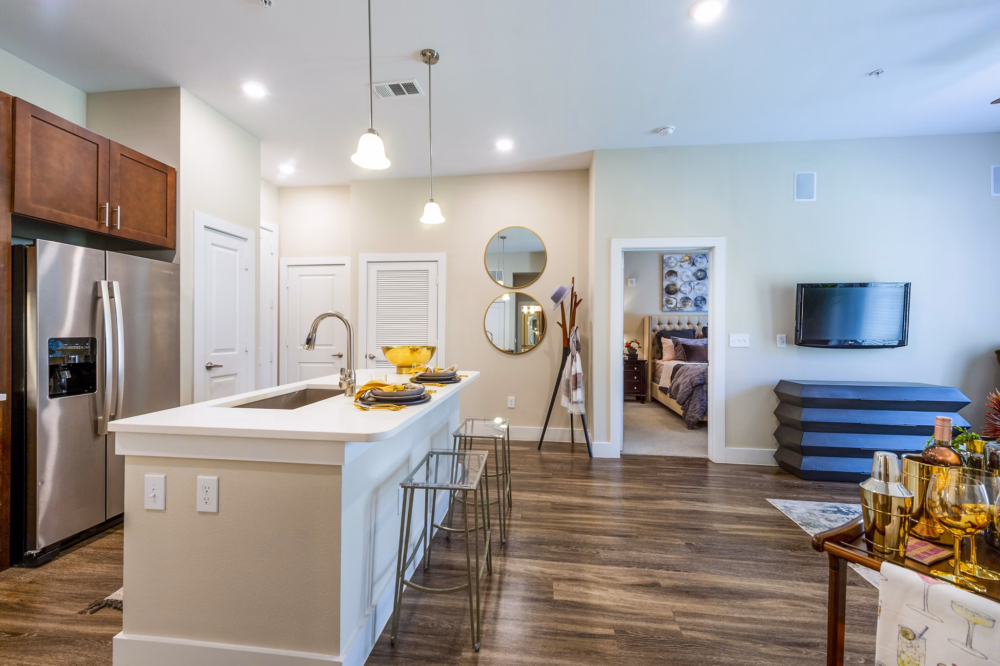 Kitchen featuring modern stainless steel appliances and granite countertops in Hardy Yards Apartment Homes