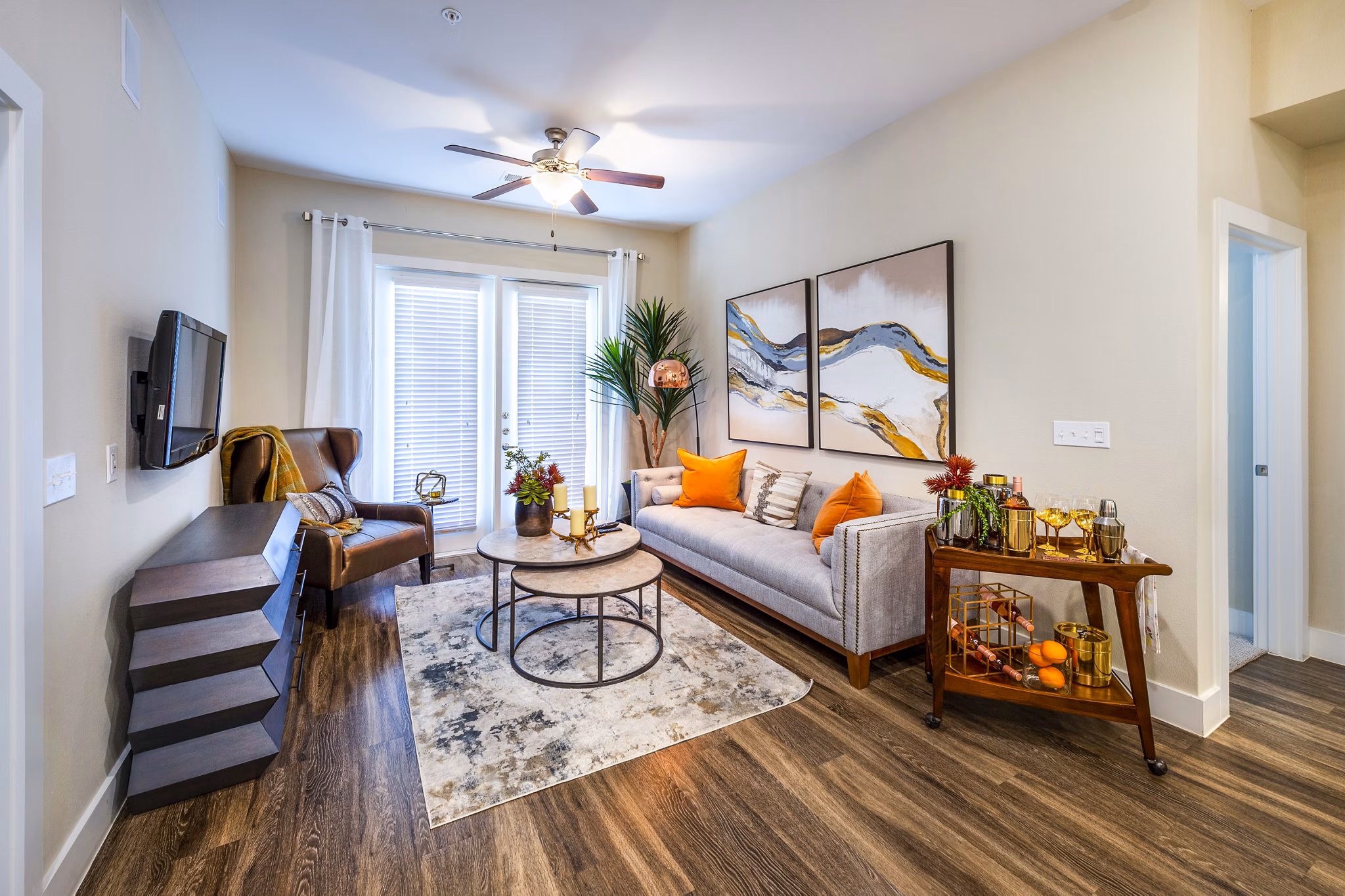 Spacious living room with modern decor and large windows in Hardy Yards Apartment Homes