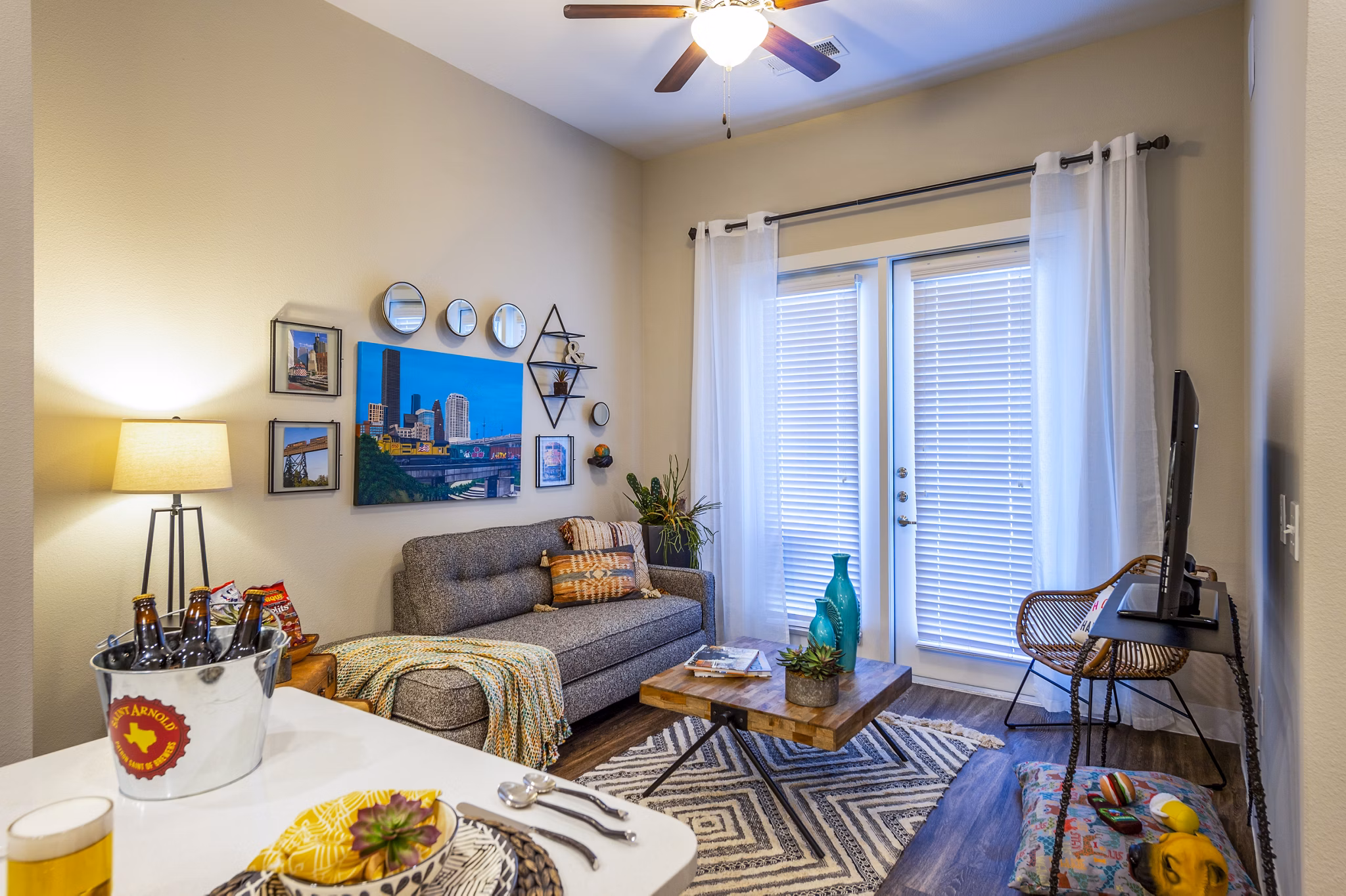 Modern living room with plush seating and large windows at Hardy Yards Apartment Homes
