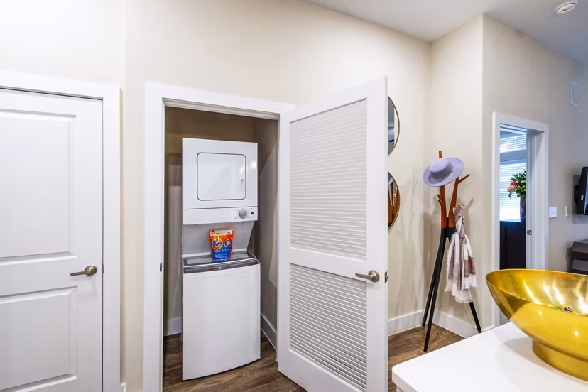 Laundry room with modern appliances at Hardy Yards Apartment Homes