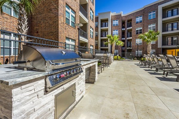 Outdoor grill area with modern seating at Hardy Yards Apartment Homes