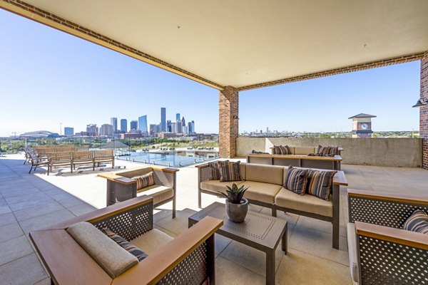 Patio with modern seating at Hardy Yards Apartment Homes, offering beautiful outdoor space adjacent to the luxury apartments