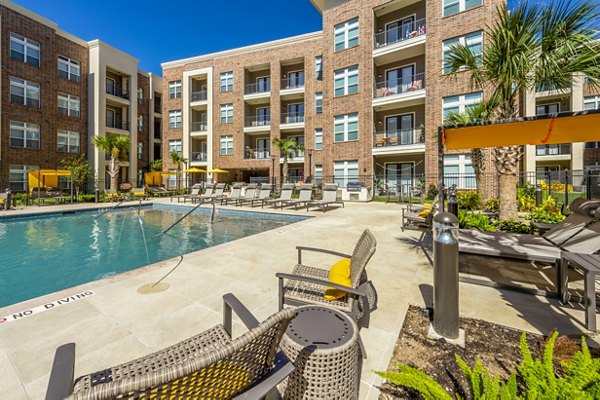 Modern pool area with stylish lounge chairs at Hardy Yards Apartment Homes, ideal for relaxation and leisure activities