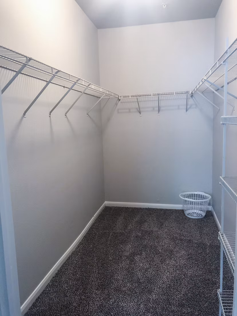 Organized bedroom closet with ample shelving at Breakers at Windmill Lakes Apartments