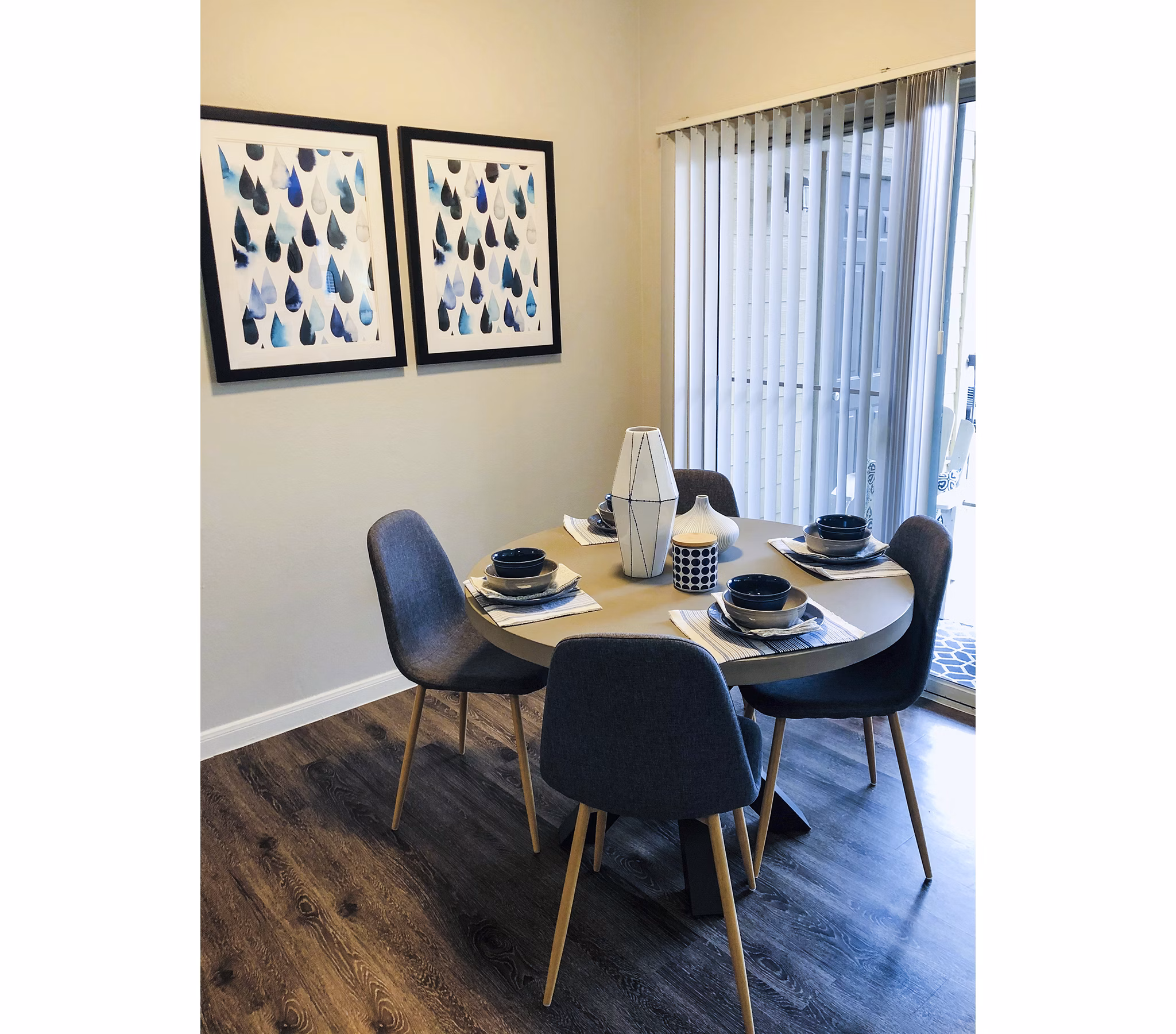 Dining room with elegant chandelier and modern decor at Breakers at Windmill Lakes Apartments