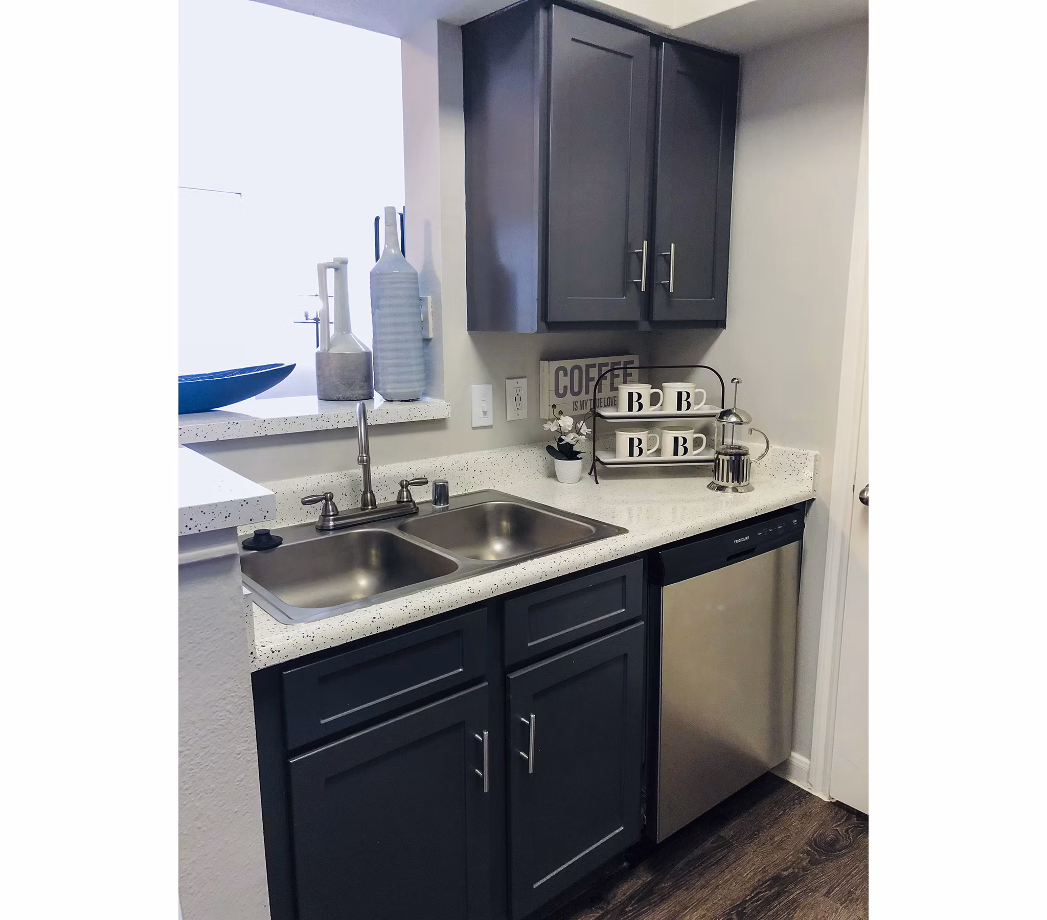 Modern kitchen with sleek countertops and stainless steel appliances in Breakers at Windmill Lakes Apartments