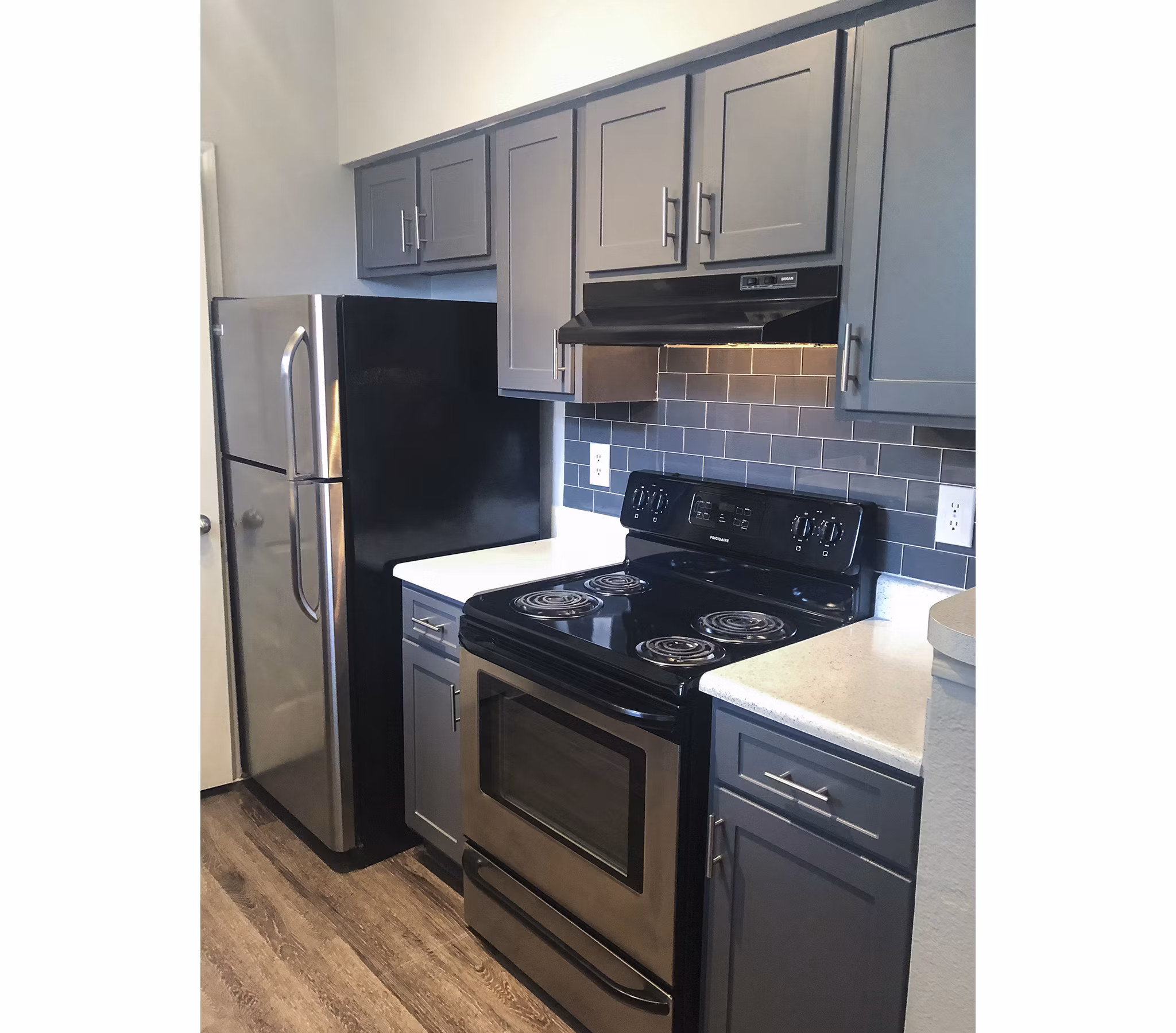 Modern kitchen with sleek countertops and stainless steel appliances at Breakers at Windmill Lakes Apartments