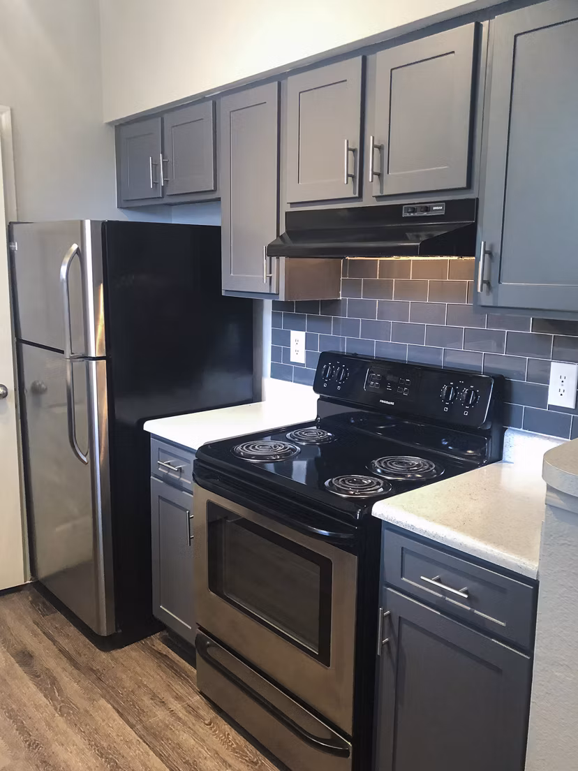 Modern kitchen with sleek countertops and stainless steel appliances at Breakers at Windmill Lakes Apartments
