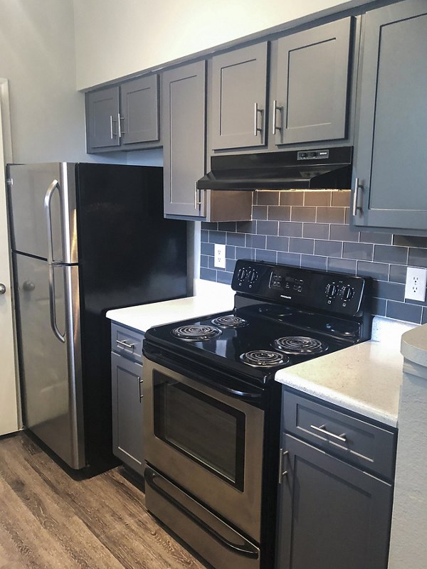 Modern kitchen with sleek countertops and stainless steel appliances at Breakers at Windmill Lakes Apartments
