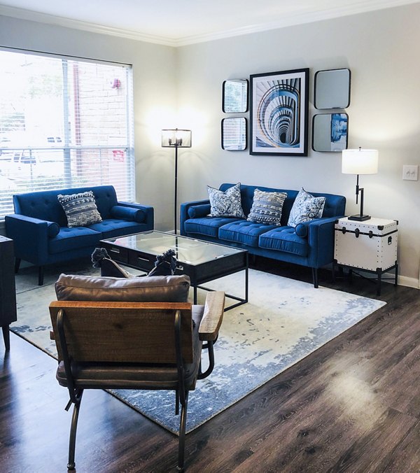 Spacious living room with elegant decor in Breakers at Windmill Lakes Apartments